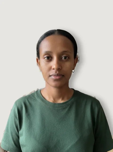 ID-style photo of a woman with a dark shadow on the wall behind her